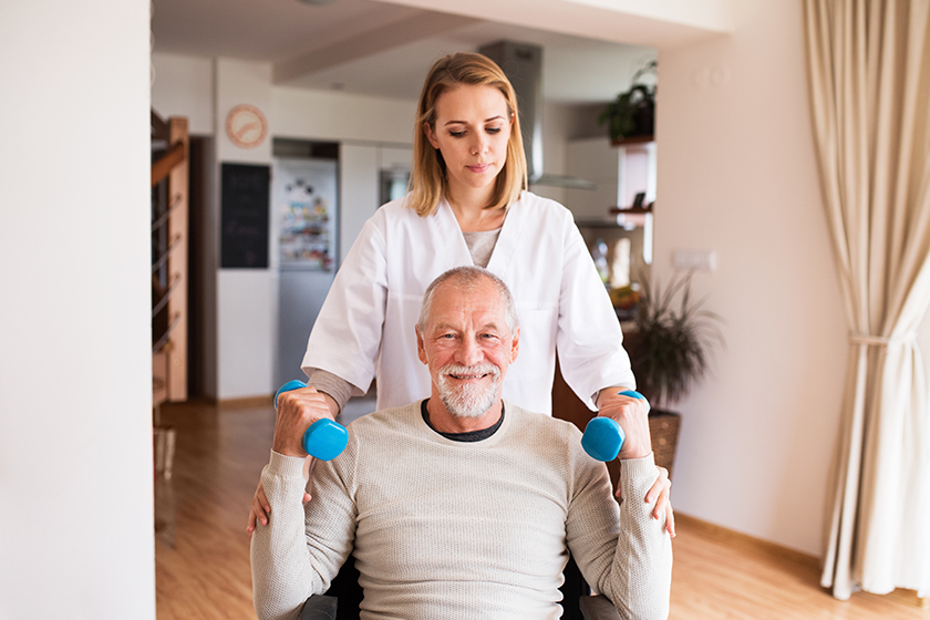 nurse and senior man in wheelchair during home visit nurse and senior man in wheelchair during home visit