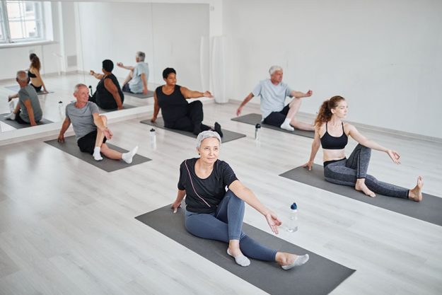 people doing yoga in class people doing yoga in class