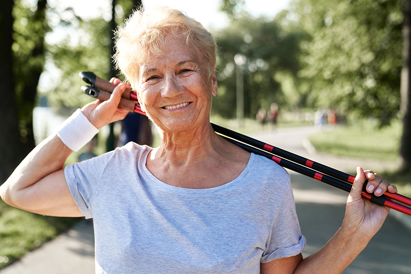 portrait senior woman holding nordic walking sticks park portrait senior woman holding nordic walking sticks park