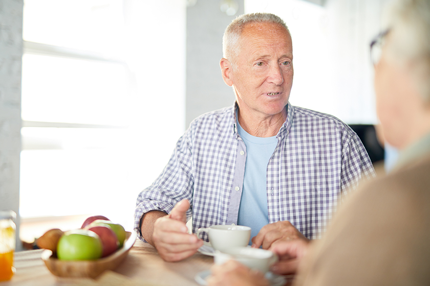 senior man casualwear sitting table having tea talking his wife senior man casualwear sitting table having tea talking his wife