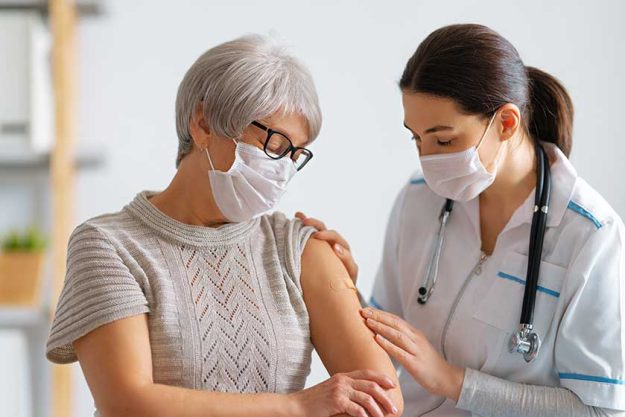 senior woman vaccination her doctor virus protection covid