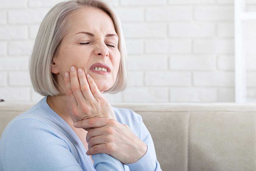 teeth problem woman feeling tooth pain closeup of beautiful middle aged suffering from strong toothache teeth problem woman feeling tooth pain closeup of beautiful middle aged suffering from strong toothache