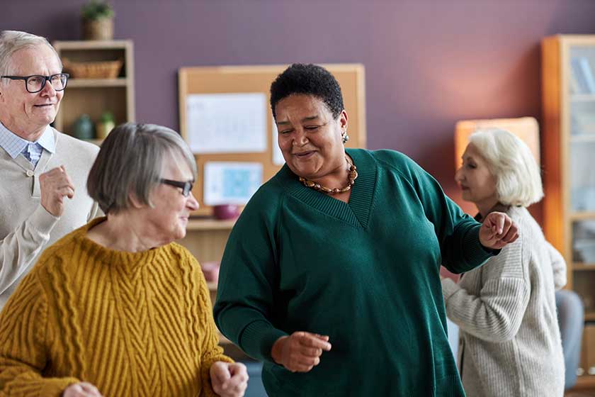 waist portrait black senior woman dancing friends retirement home smiling waist portrait black senior woman dancing friends retirement home smiling