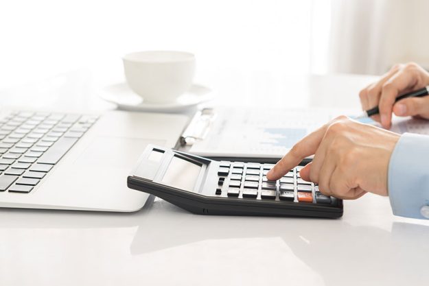 accounting businessman using a calculator