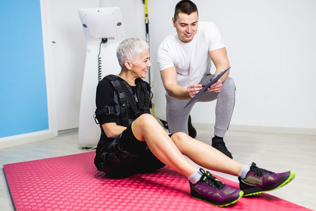 beautiful senior woman doing exercises electrical muscular stimulation suit her beautiful senior woman doing exercises electrical muscular stimulation suit her