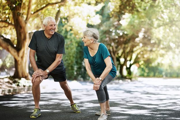 boosting long term wellbeing together senior couple warming run
