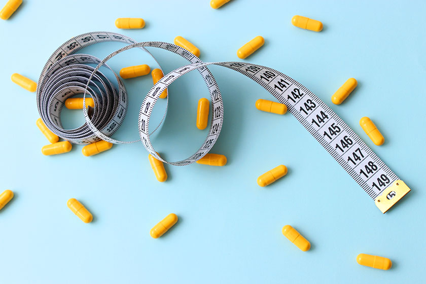 centimeter tape pills colored background space text concept losing weight centimeter tape pills colored background space text concept losing weight