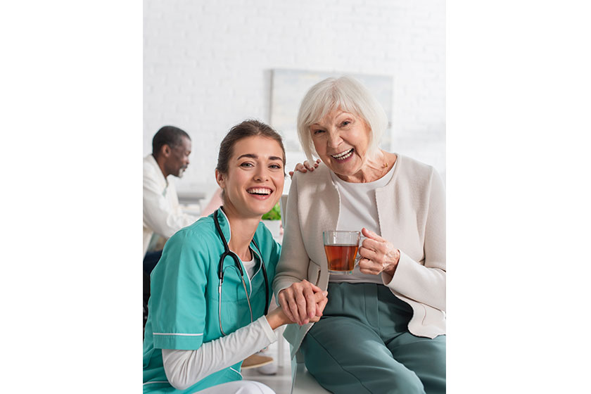 cheerful nurse holding hand smiling senior woman tea nursing home cheerful nurse holding hand smiling senior woman tea nursing home
