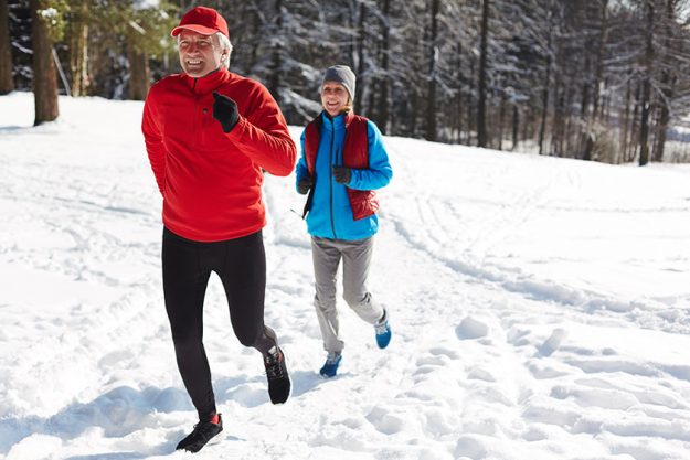 happy mature man woman sportswear running snowdrift winter morning happy mature man woman sportswear running snowdrift winter morning