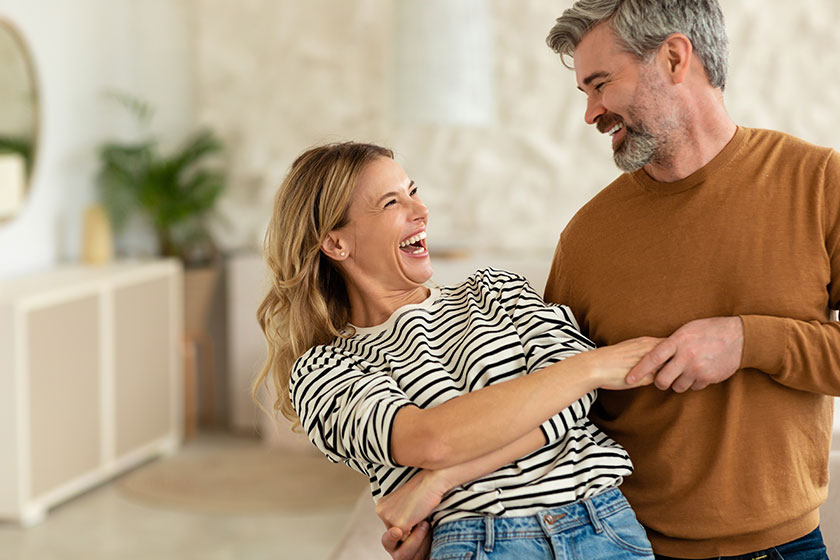 happy relationship joyful middle aged spouses dancing modern living room
