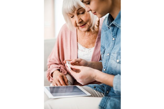 old lady and young woman checking thermometer readings