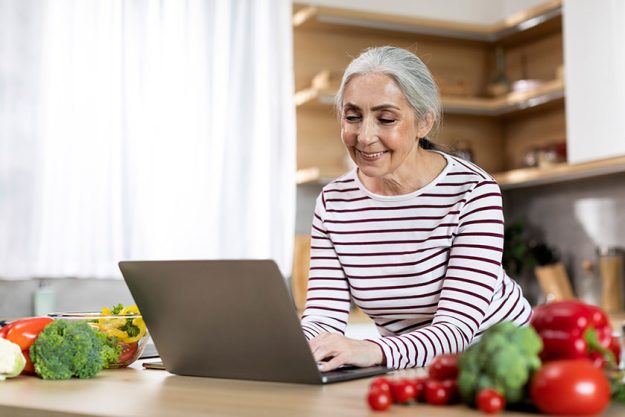 portrait smiling elderly lady using laptop kitchen happy senior woman portrait smiling elderly lady using laptop kitchen happy senior woman