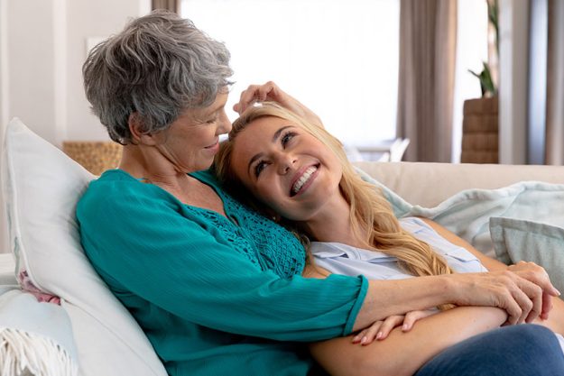 senior caucasian woman wearing green shirt her adult daughter long
