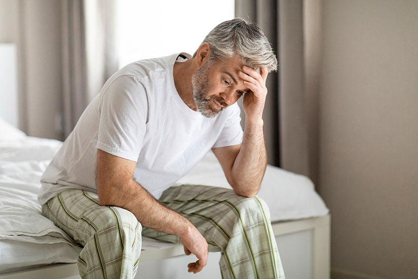 upset thoughtful middle aged grey haired handsome man wearing pajamas