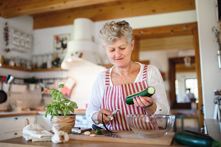 woman cooking indoors at home corona virus concept