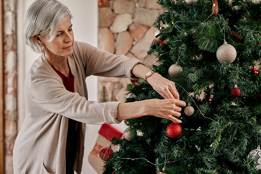 you can go right here cropped shot of a carefree mature woman placing decorations on