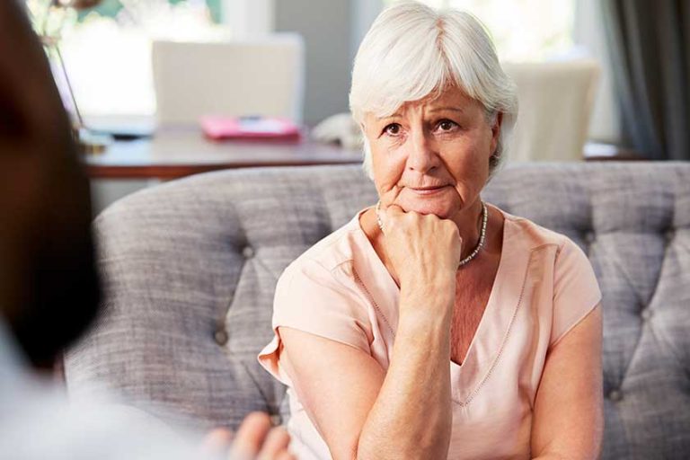 depressed senior woman having therapy psychologist