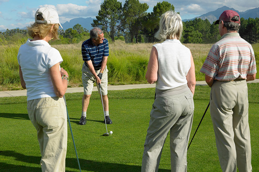 group portrait happy friends playing golf