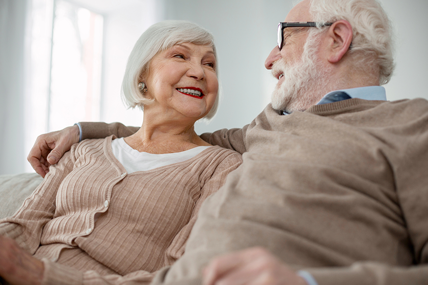happy elderly people looking at each other