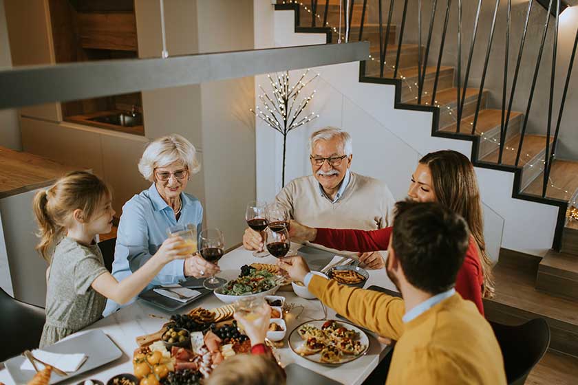 happy family having dinner red wine home