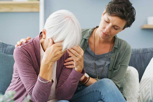 have bad headache attractive young woman sitting comforting her senior have bad headache attractive young woman sitting comforting her senior