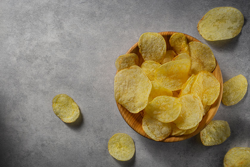 potato chips wooden bowl concrete background
