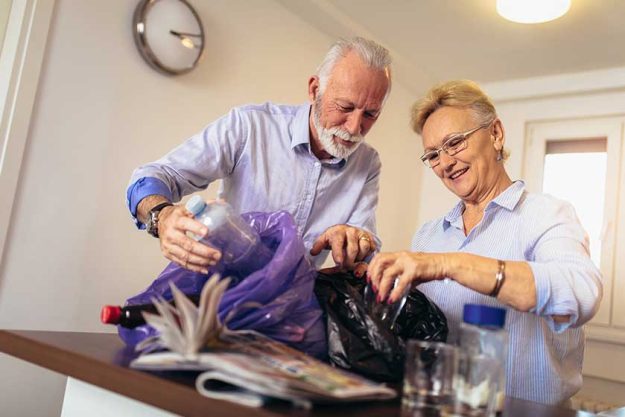 senior couple separating recyclable trash home senior couple separating recyclable trash home