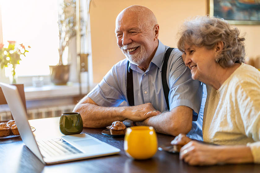 senior couple using laptop home