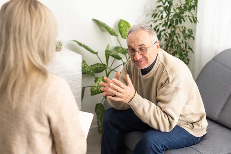 senior man patient young woman caregiver medical worker uniform hold