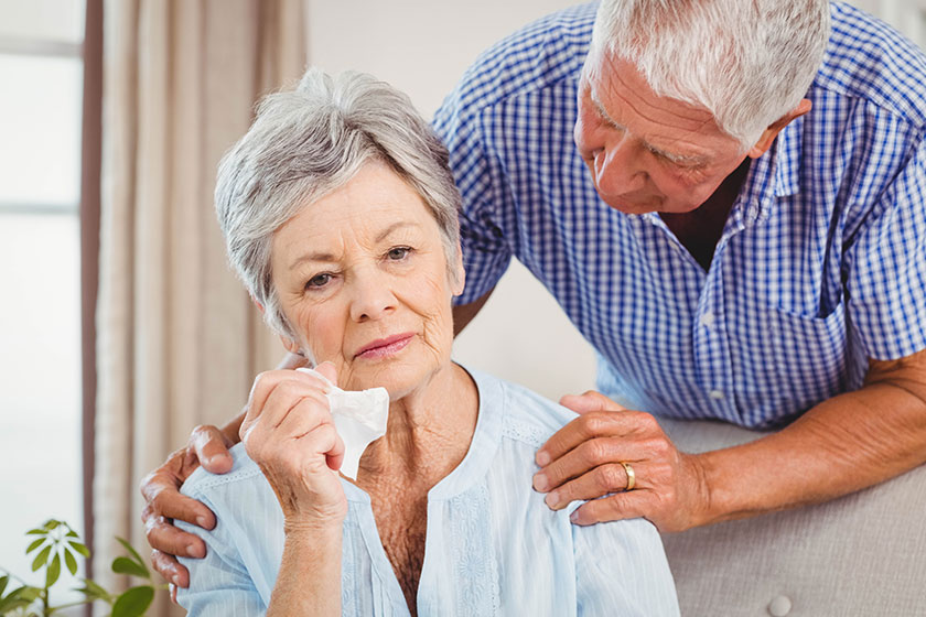 senior man talking to upset woman