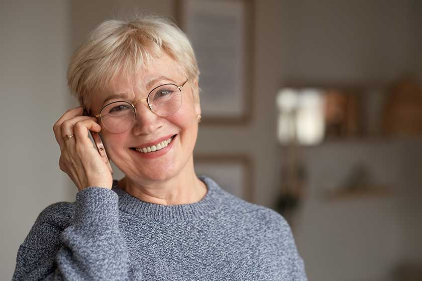 senior woman smiling talking on phone at home senior woman smiling talking on phone at home