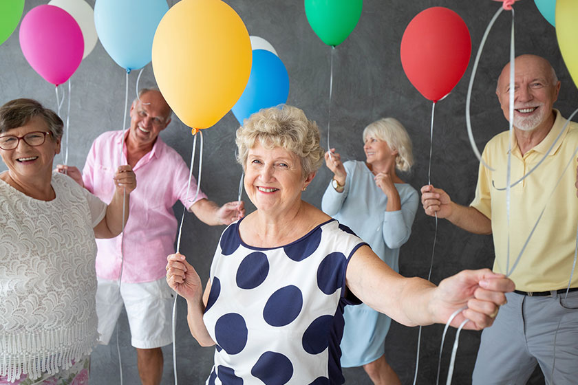 smiling grandmother happy friends colorful balloons party
