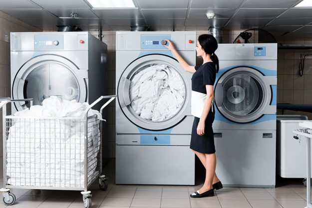 cheerful maid touching button washing machine laundry cheerful maid touching button washing machine laundry