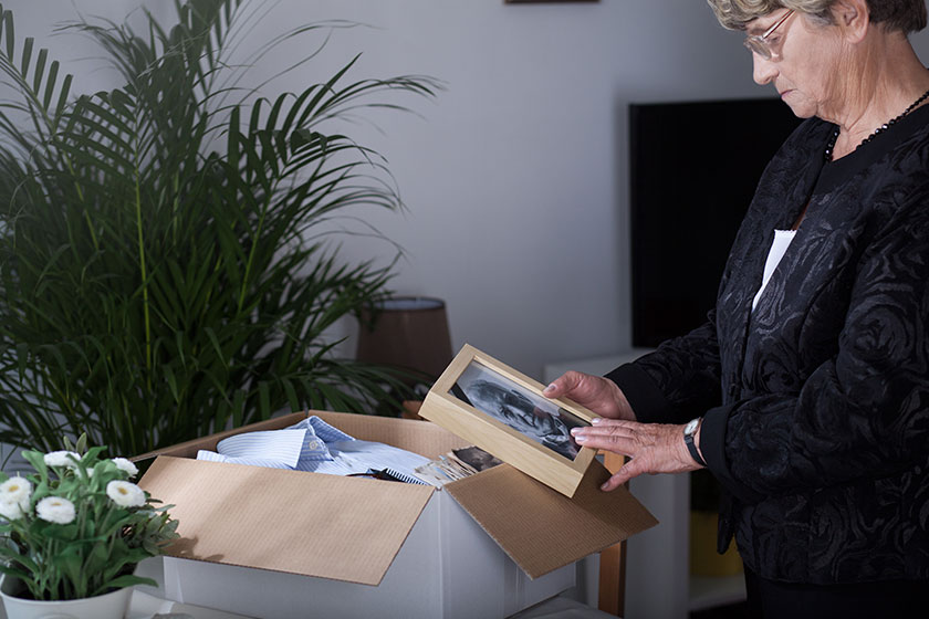 elderly woman holding old picture
