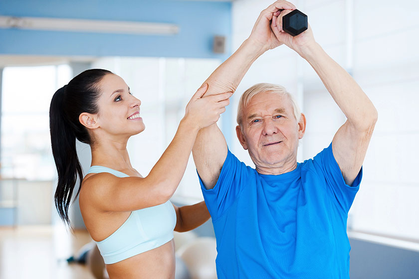 physical therapist working with senior man