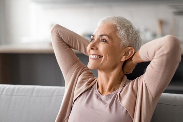 relaxed senior lady enjoying quiet pause comfortably leaning back her