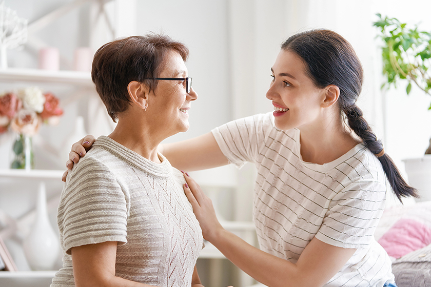 beautiful mother daughter hugging talking smiling while sitting couch home beautiful mother daughter hugging talking smiling while sitting couch home
