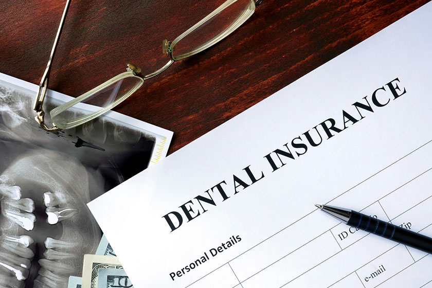 Dental insurance form on the wooden table Dental insurance form on the wooden table