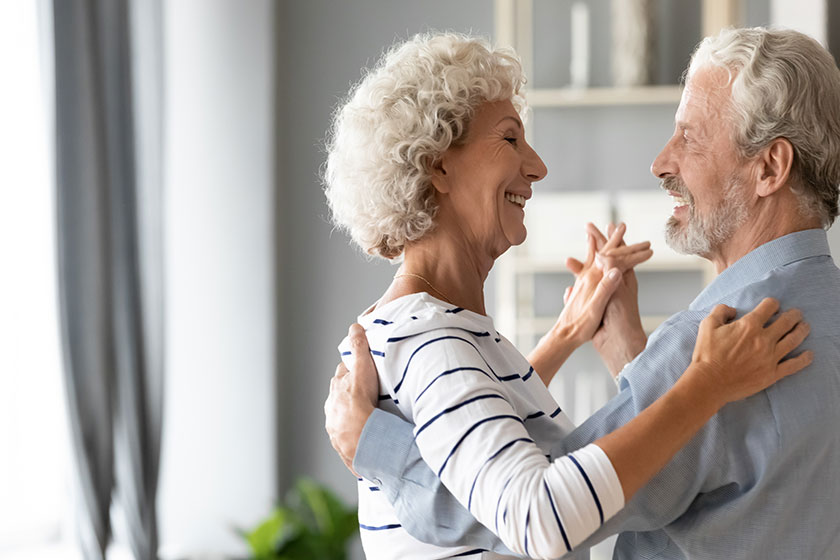 Happy romantic older retired family couple dancing at home Happy romantic older retired family couple dancing at home