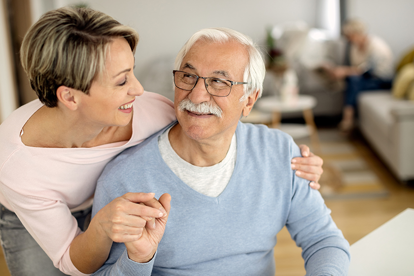 happy woman her senior father holding hands while communicating home happy woman her senior father holding hands while communicating home