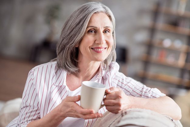 photo of happy cheerful positive old lady good mood hold hands mug weekend indoors inside photo of happy cheerful positive old lady good mood hold hands mug weekend indoors inside
