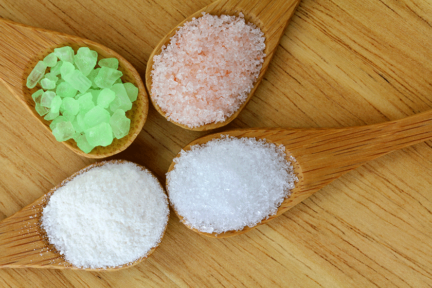 4 types of salt in a wooden spoon