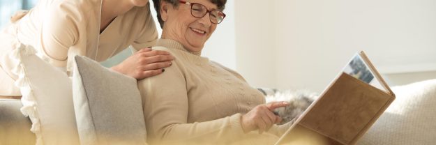 Panorama,Of,Smiling,Elderly,Woman,Reading,A,Book,In,A