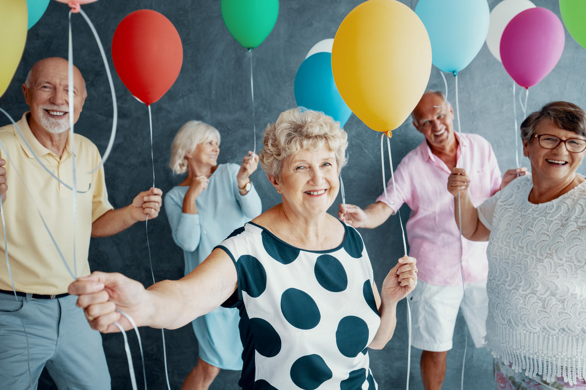Smiling,Grandmother,Wearing,A,White,Blouse,With,Black,Dots,And