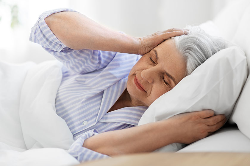 annoyed senior woman with headache in bed at home annoyed senior woman with headache in bed at home