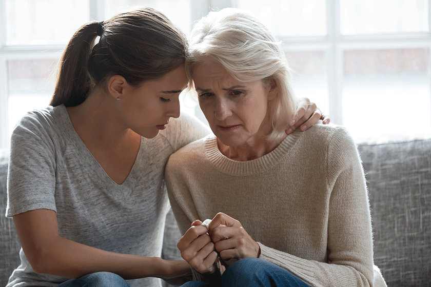 caring adult comfort unhappy crying elderly mother