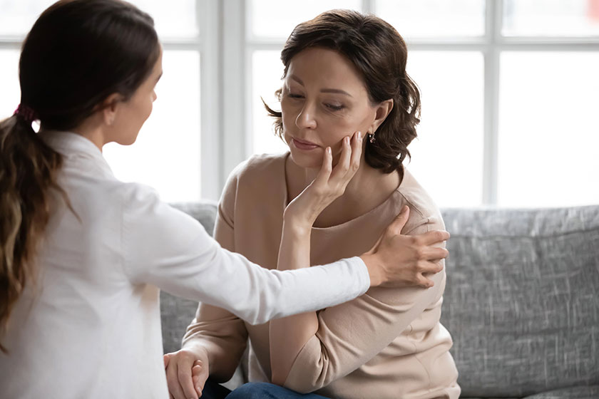 caring grownup daughter support upset mature mother