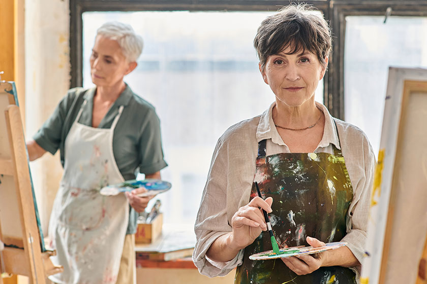creative mature woman holding color palette looking camera master class