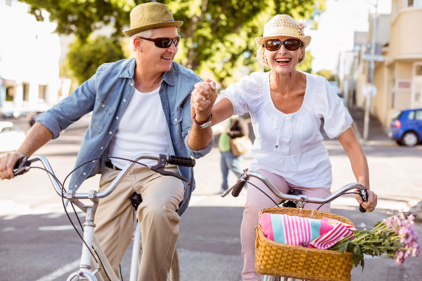 happy mature couple going for a bike ride in the city happy mature couple going for a bike ride in the city
