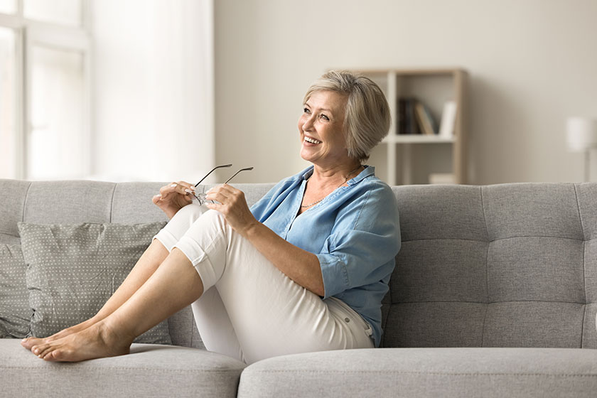 happy satisfied old lady taking glasses looking away smiling laughing